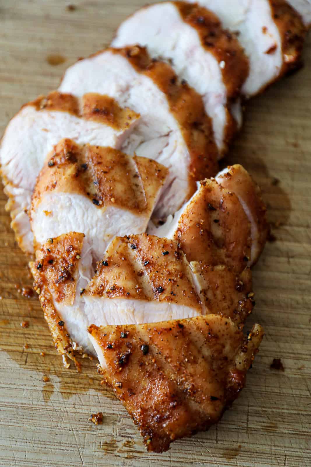 Sliced Smoked Chicken Breast on a cutting board