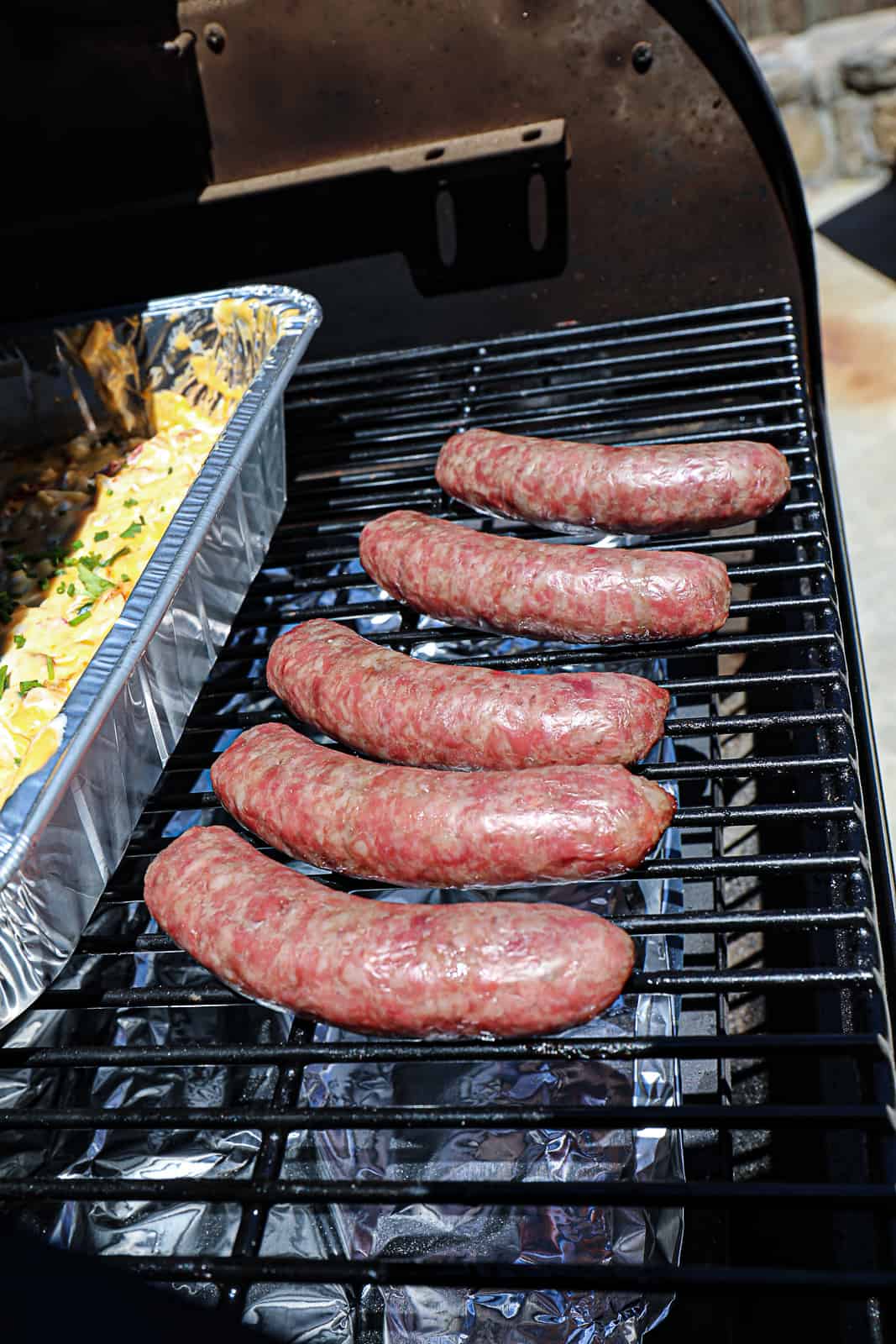 Smoking beer brats on the pellet grill with queso dip appetizer