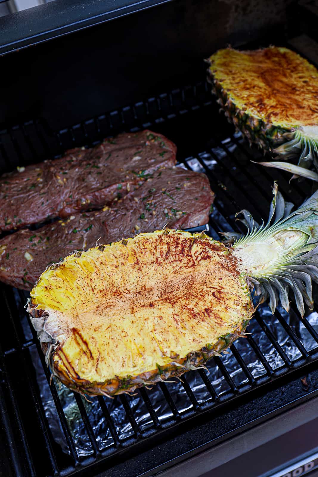 Smoking pineapple at 225 degrees F with steak on the Traeger