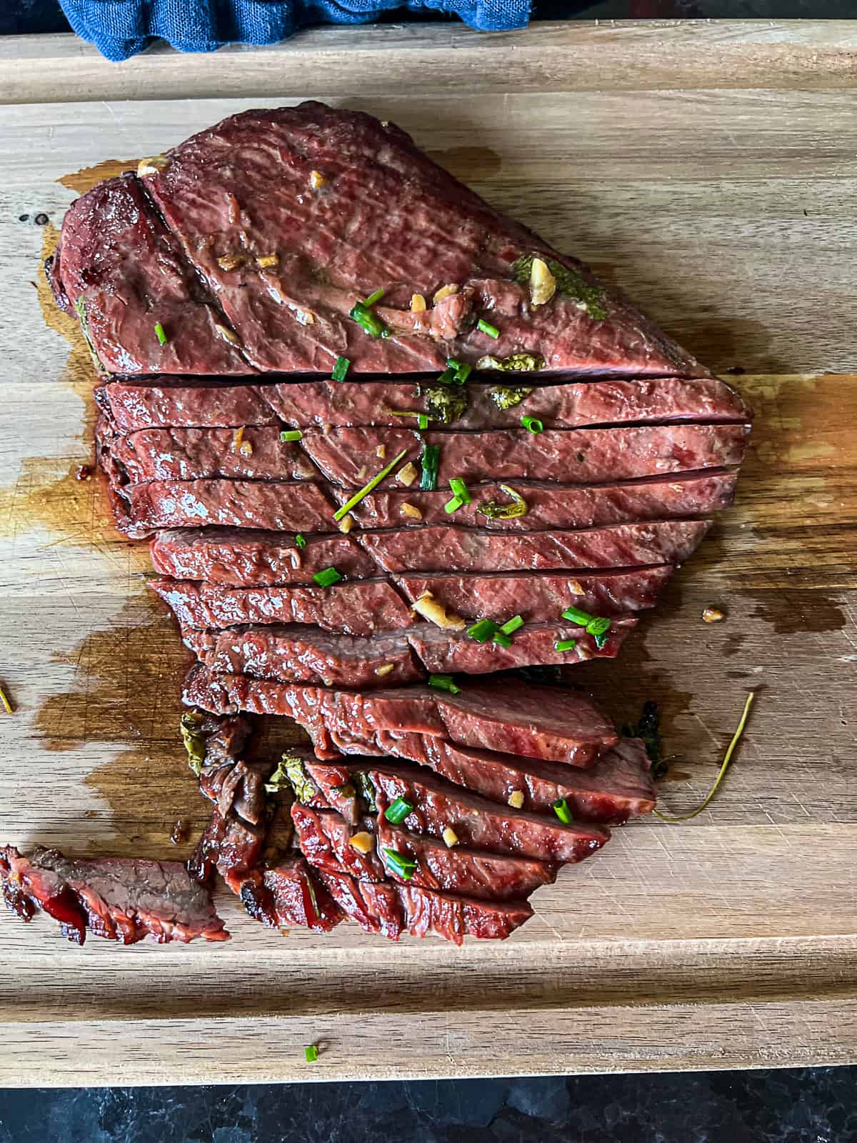 Traeger Pellet Smoker Flank Steak Sliced On A Cutting Board