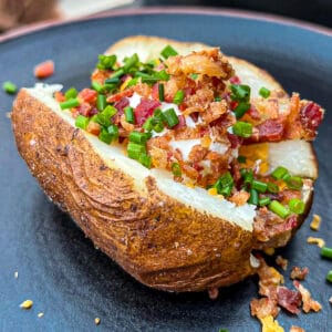 Traeger Smoked Baked Potatoes Loaded with bacon and toppings