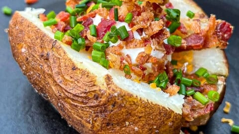 Traeger Smoked Baked Potatoes Loaded with bacon and toppings