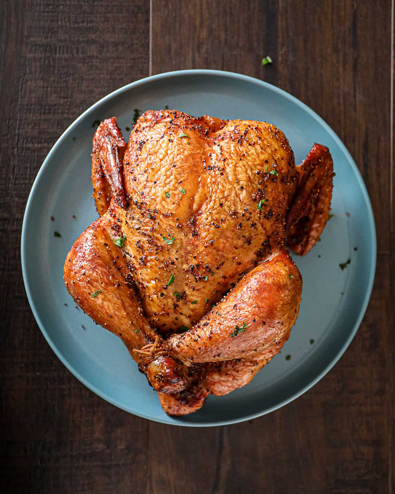 Demonstrating what a flavorful smokey whole chicken looks like