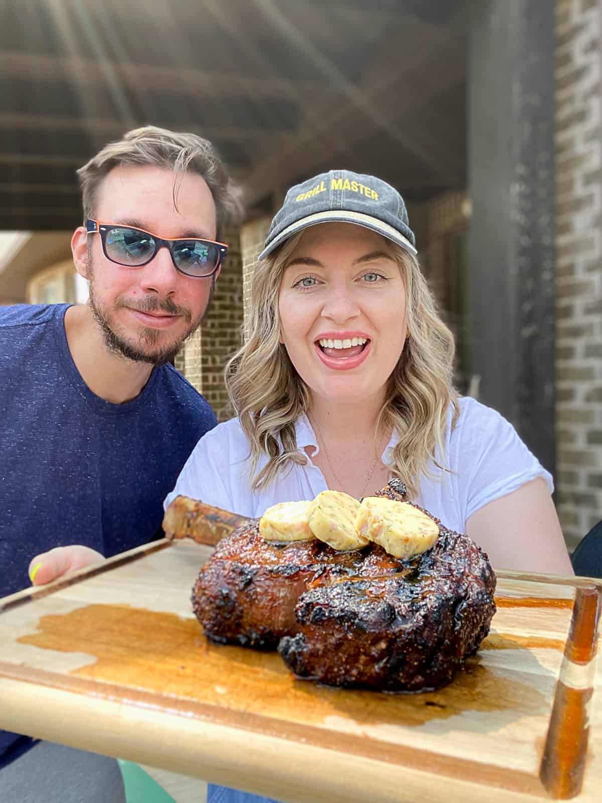Food Blogger Jenna Passaro holding Traeger Smoked Tomahawk Steak With Reverse Sear