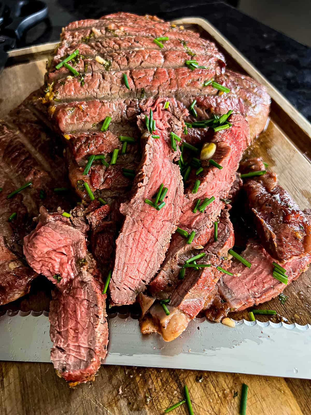 Medium Rare Traeger Smoked Sirloin Steak Sliced For Sandwiches on a Cutting Board