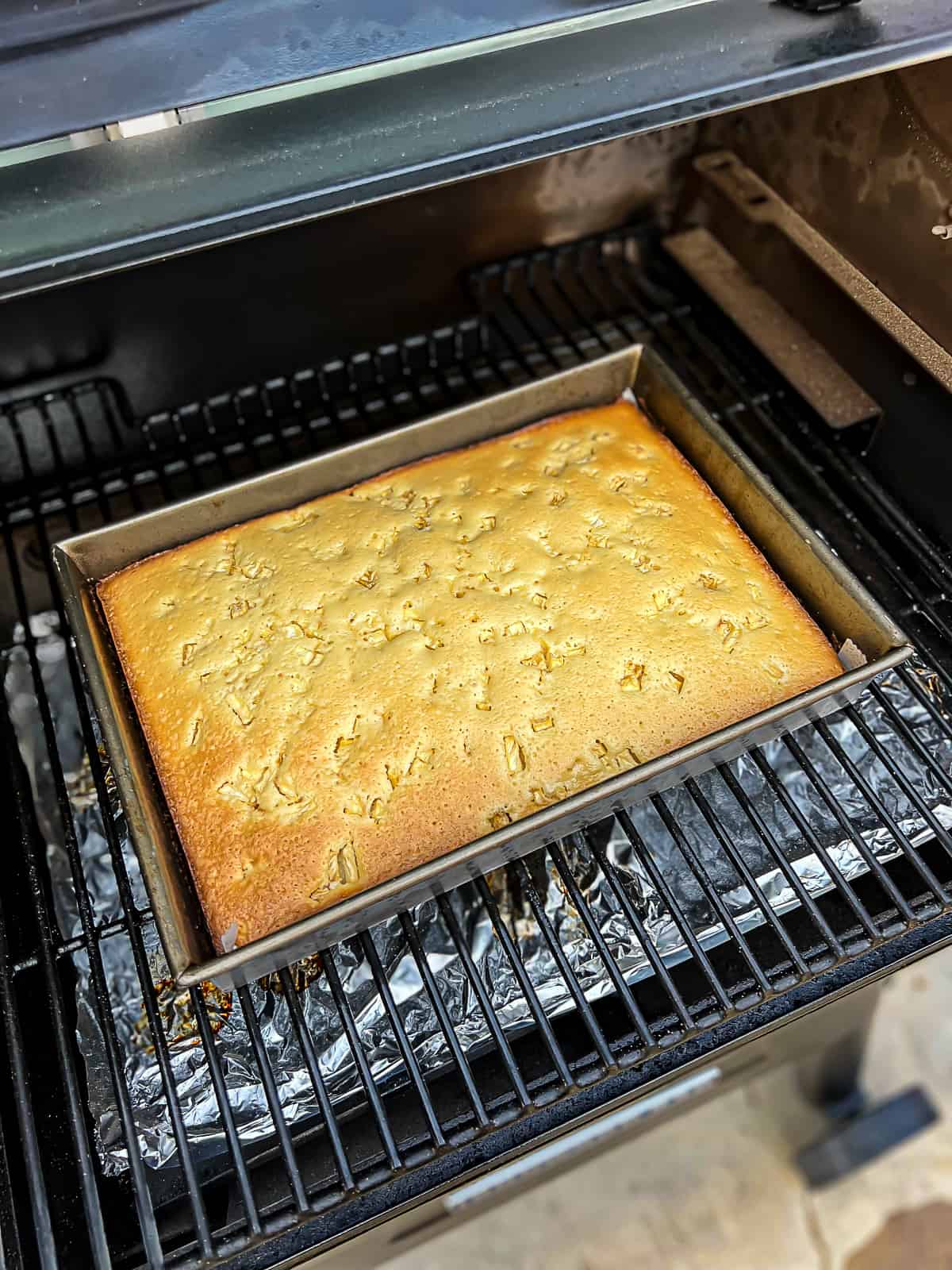 Pineapple cake smoked in the Traeger pellet grills sheet cake style