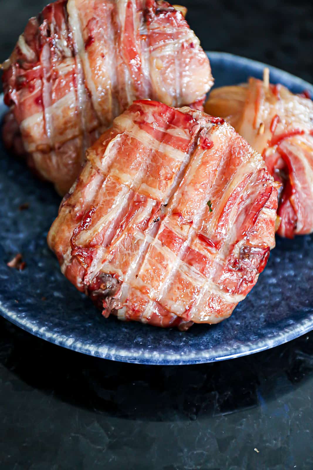 Resting Bacon Wrapped Burgers On A Plate For Serving