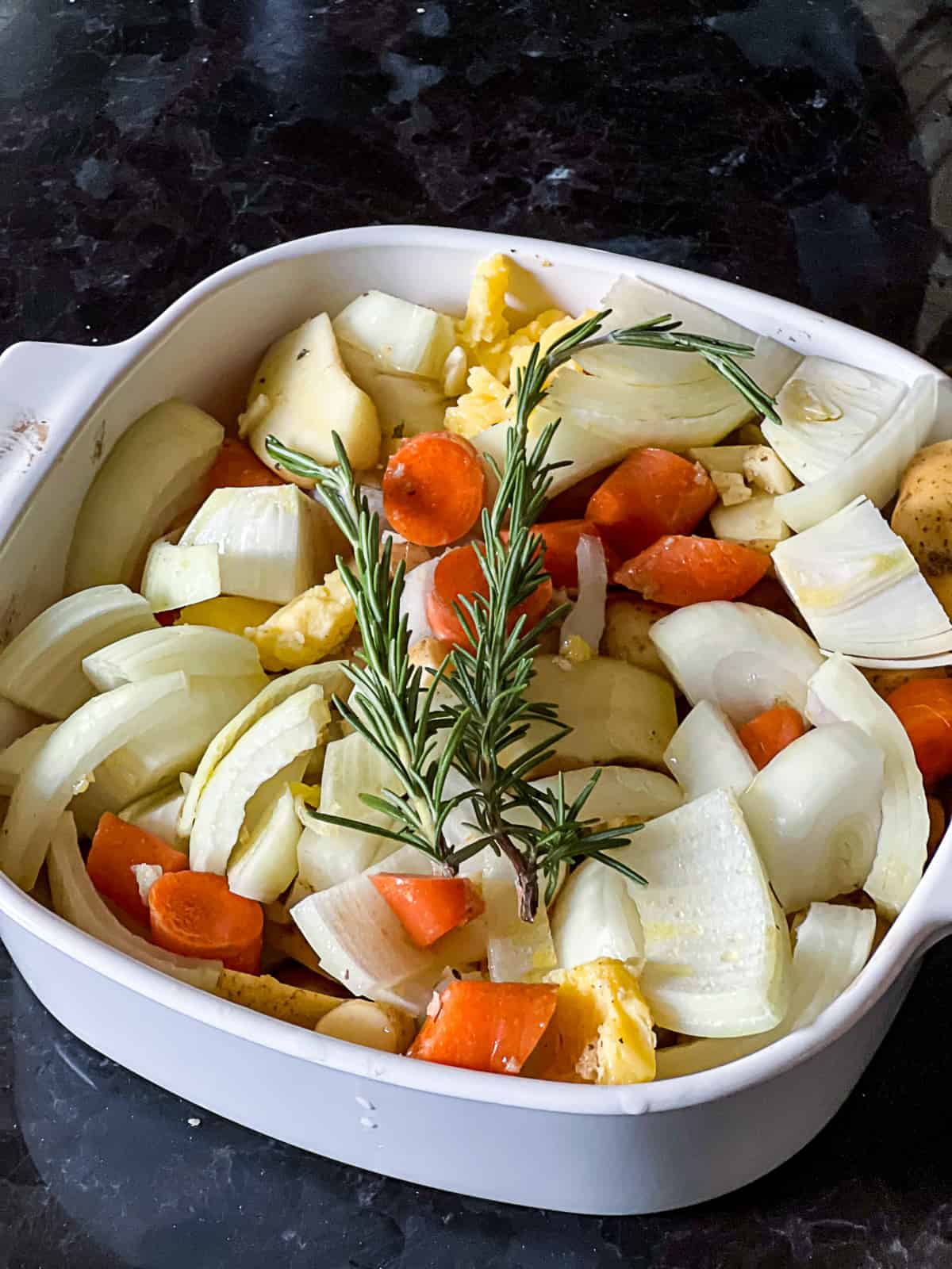 Roasting dish with recipe for Oven Baked Potatoes Carrots and Onions