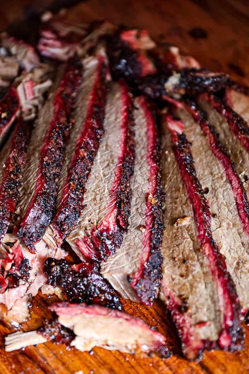 Smoked brisket meat for game day sandwiches on a cutting board