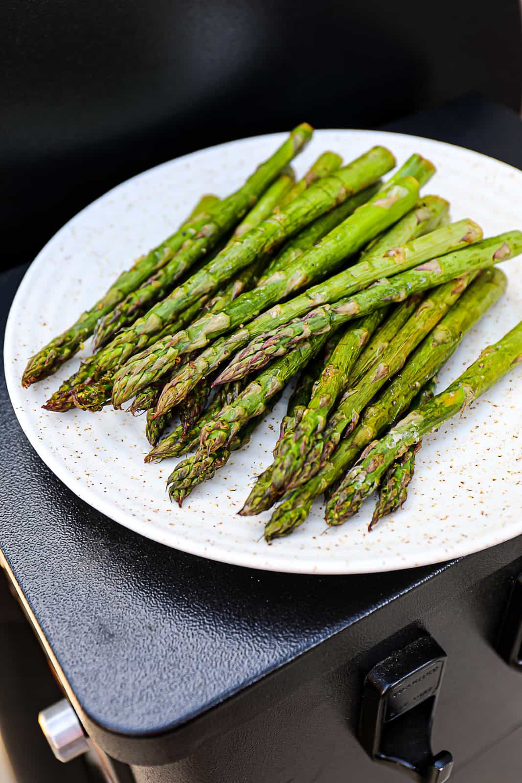 Thick Smoked Asparagus On Serving Plate Resting On The Traeger Grills