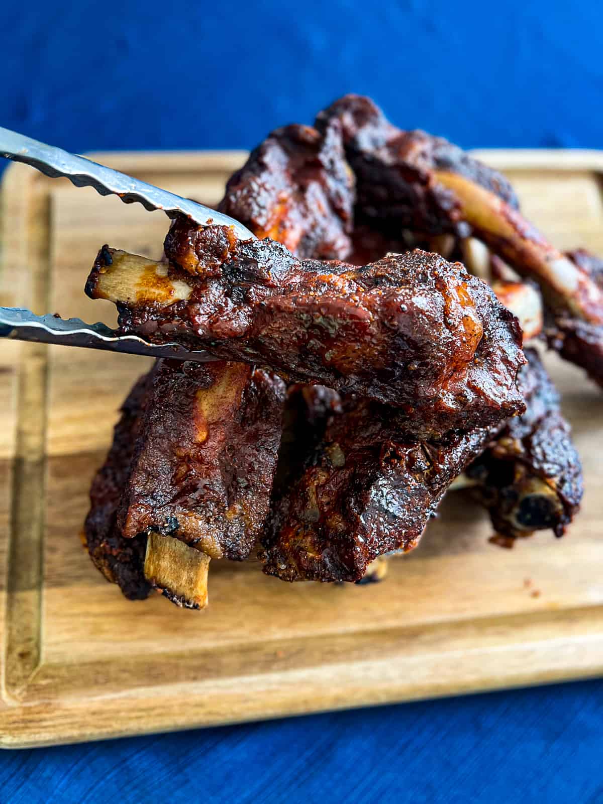 Tongs holding BBQ Beef Back Ribs