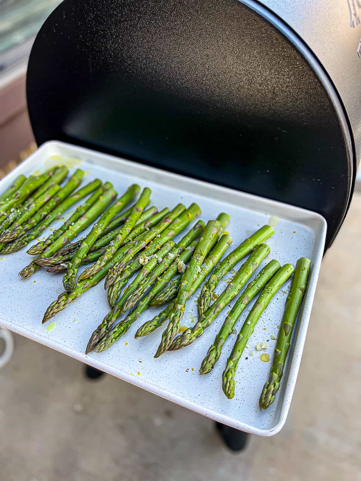 Tray Of Seasoned Asparagus On Traeger pellet grills