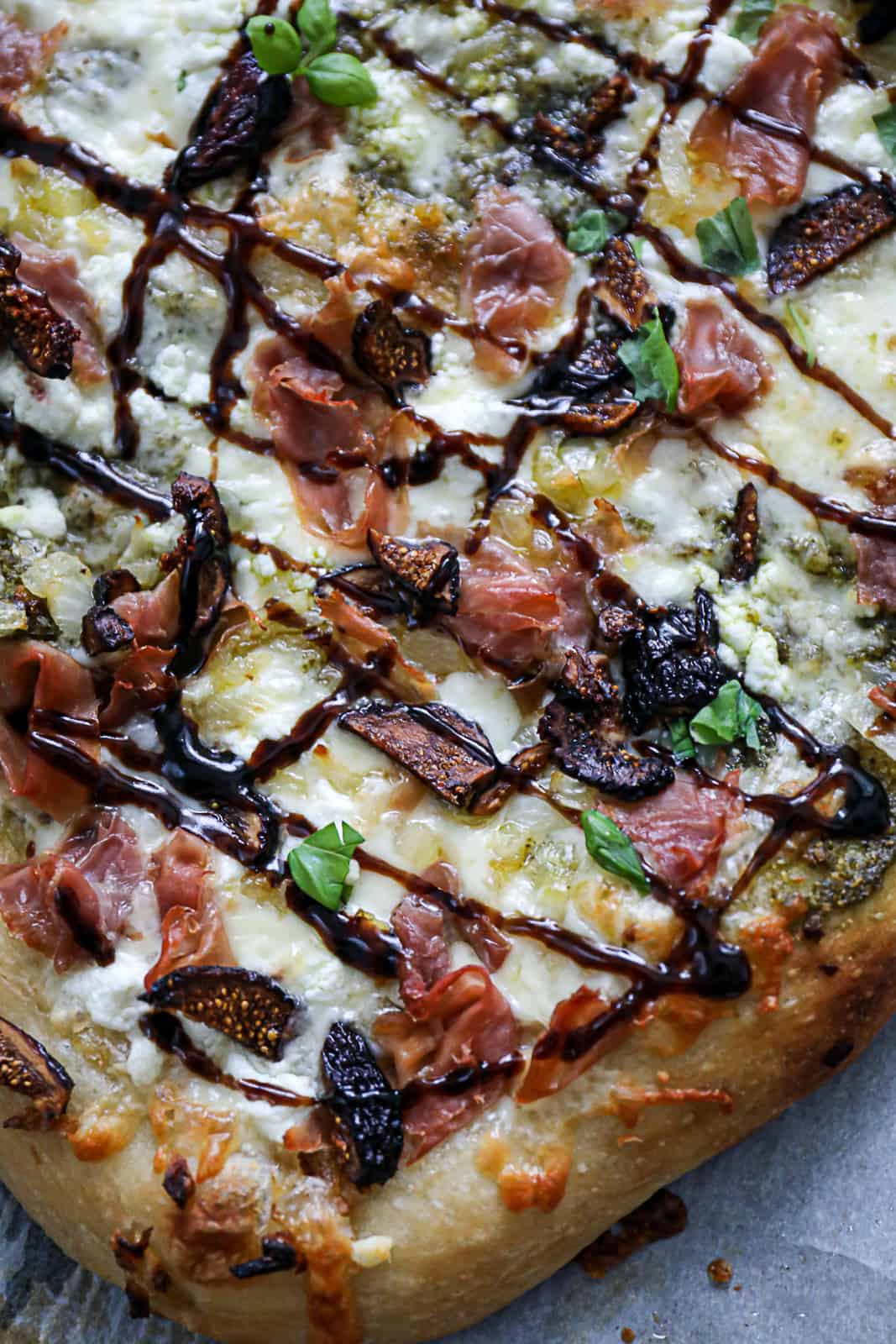 Closeup of melted Italian cheese and goat cheese on Fig And Prosciutto Flatbread Pizza