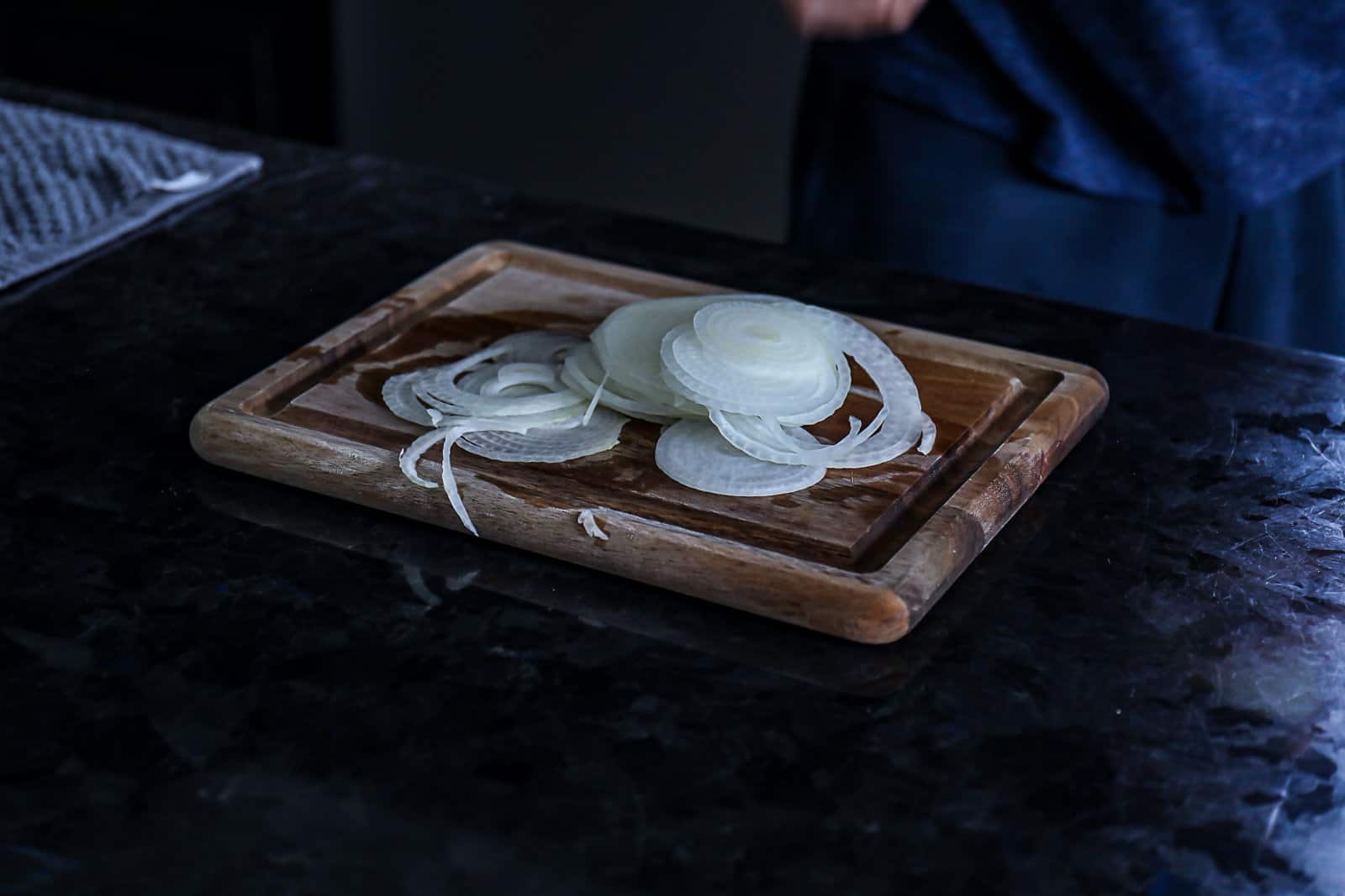 Recipe step demonstrating how to cut onions for smash burgers