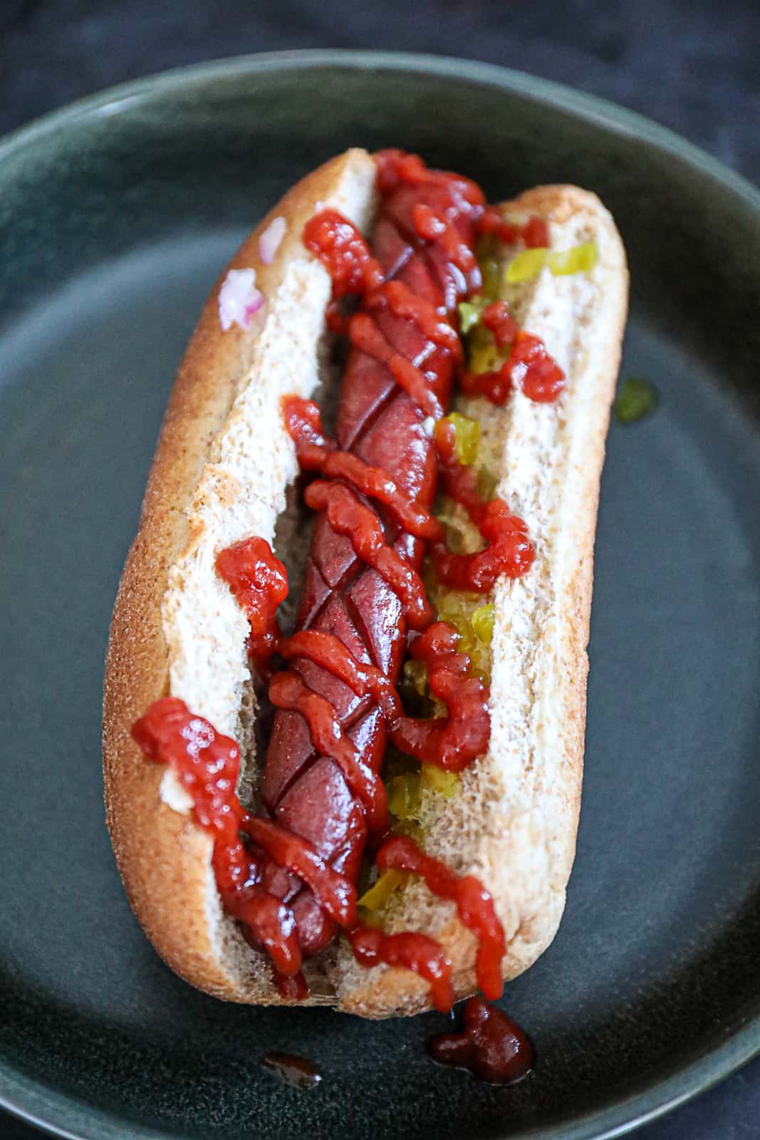 Traeger Hot Dog Smoked with Score Lines and served with ketchup and relish 