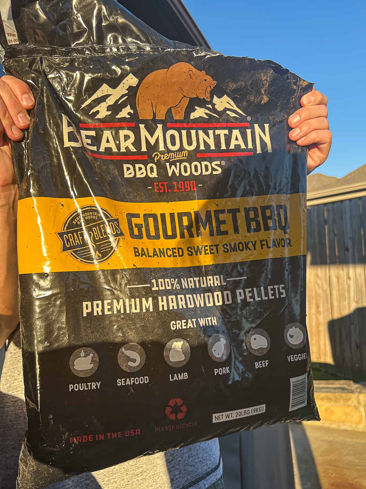 Holding Bear Mountain Pellets bag