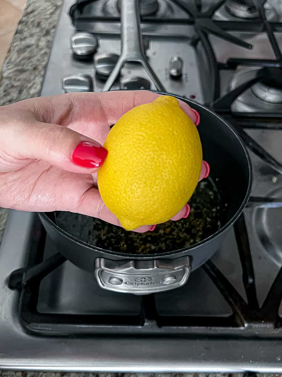 Holding a fresh lemon while making turkey gravy packet recipe