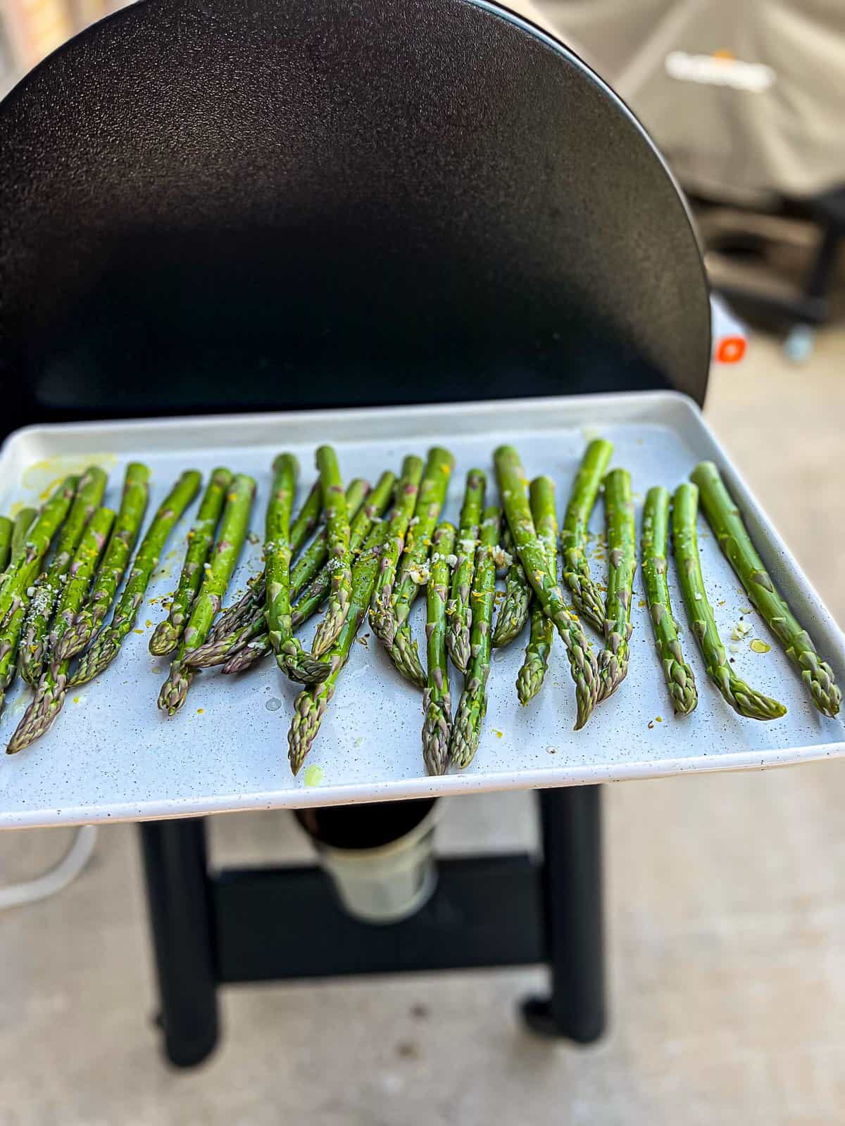 Traeger grills smoker with smoked asparagus on the pellet grill shelf