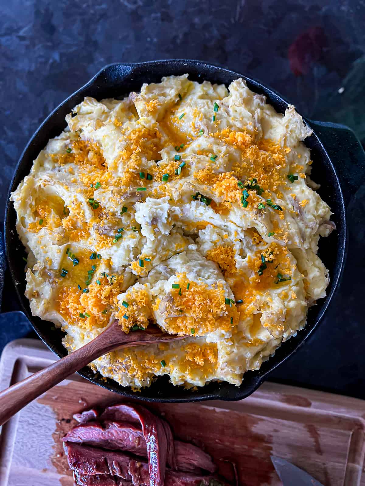 Traeger smoked side dish of mashed potatoes with cheddar cheese