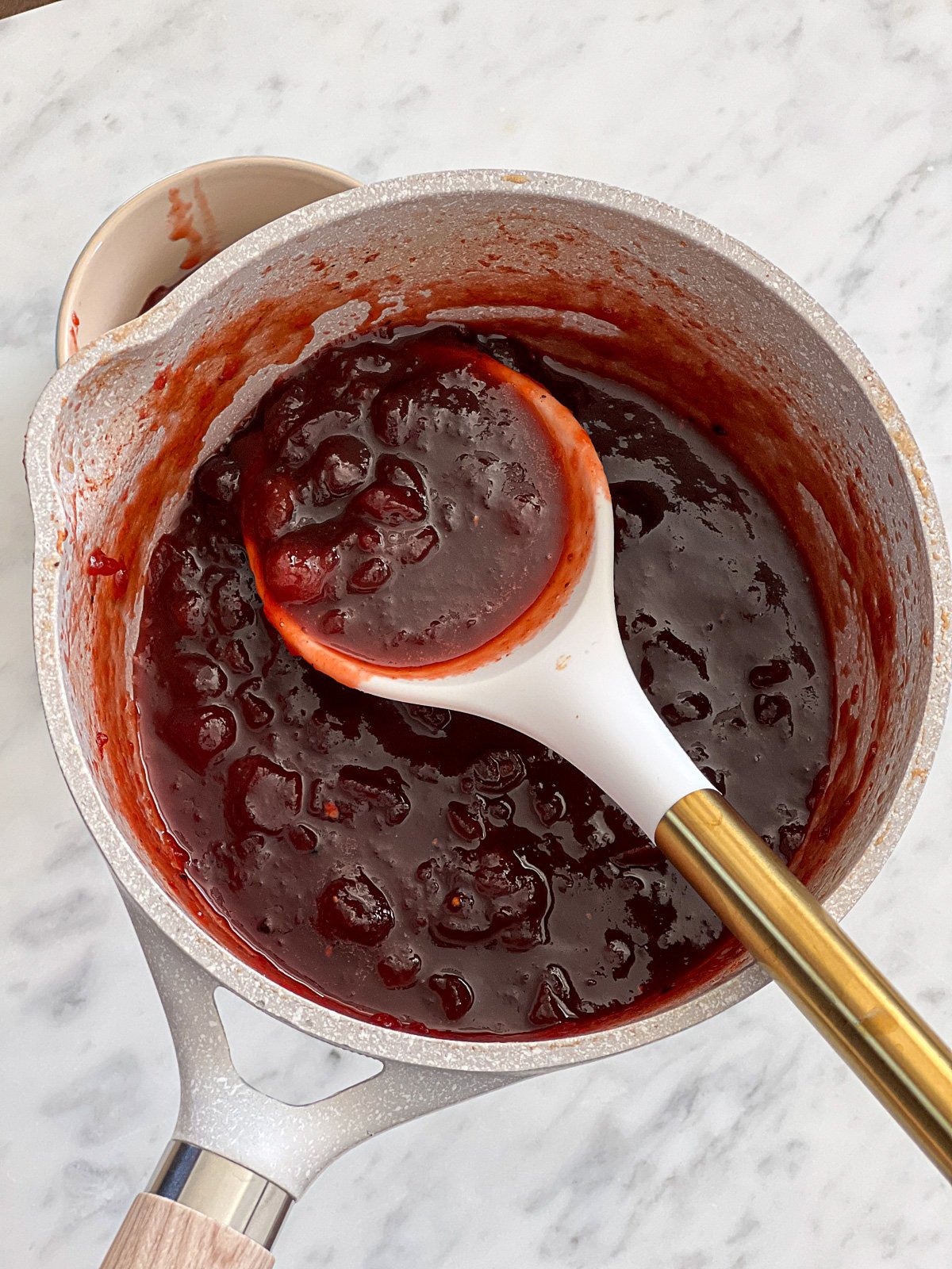 Spoonful of stovetop cooked Honey Cranberry BBQ Sauce