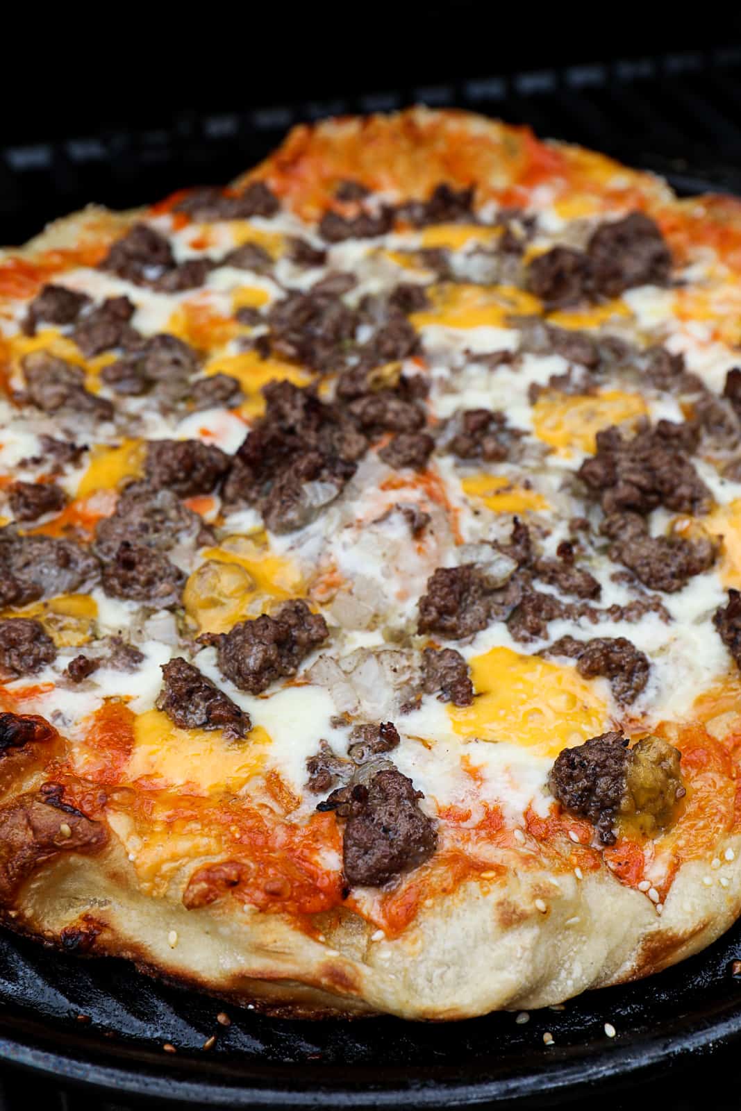 Closeup of cheeseburger pizza recipe with ground beef and cheddar