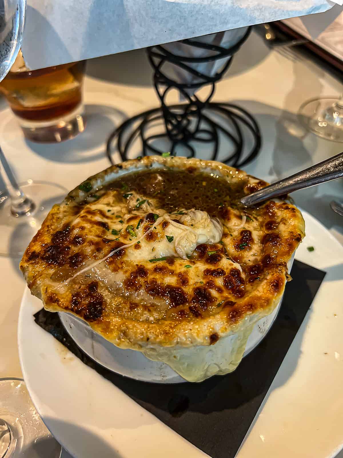 French onion soup appetizer on Toulouse Dallas area menus