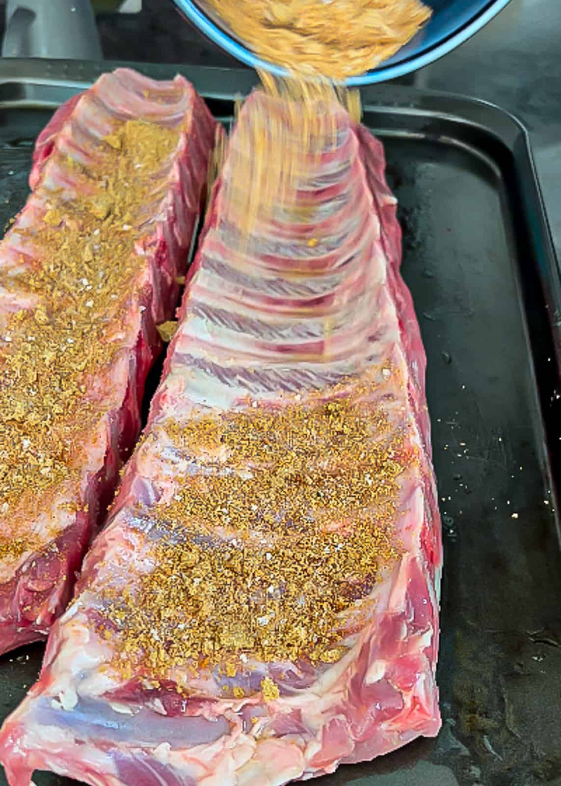 Adding pork rib rub to pork meat
