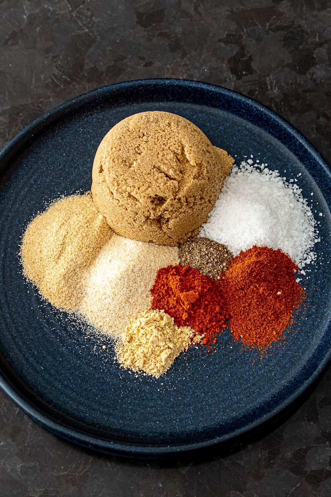 Closeup of spices in pork rib rub with brown sugar mustard powder garlic onion and more