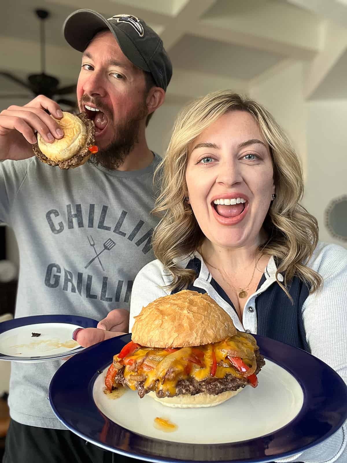 Food Bloggers Jenna Passaro holding Traeger Flatrock Griddle Philly cheesesteak smashed burgers recipe