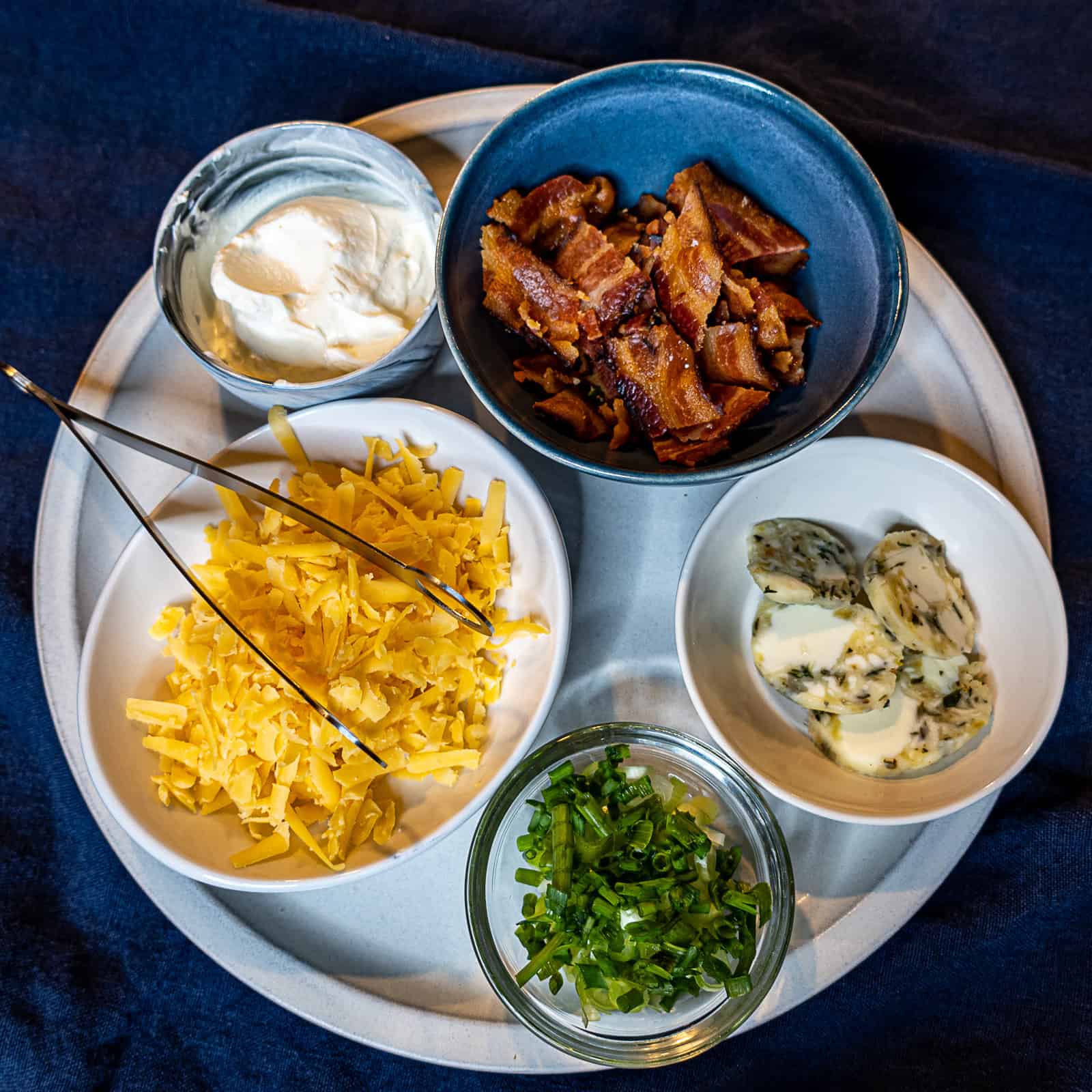 Toppings for Baked Potatoes with bacon, sour cream, cheese, chives and butter