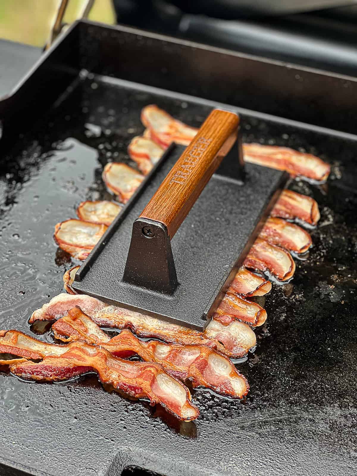 Closeup of griddling bacon on Traeger Grills Flatrock Griddle