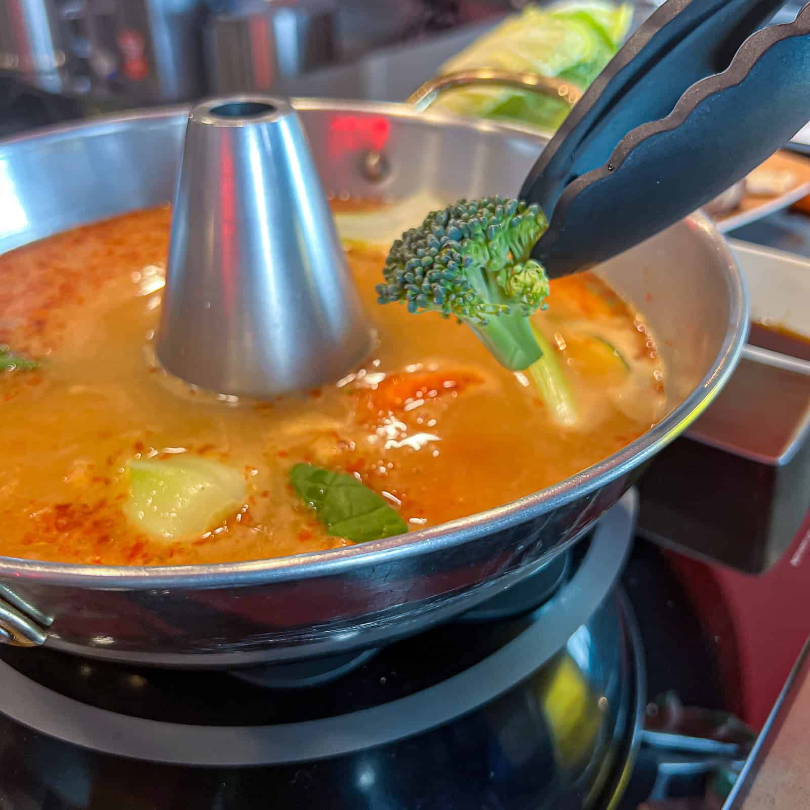 Man holding Hot Pot platter inside Tabu Shabu McKinney