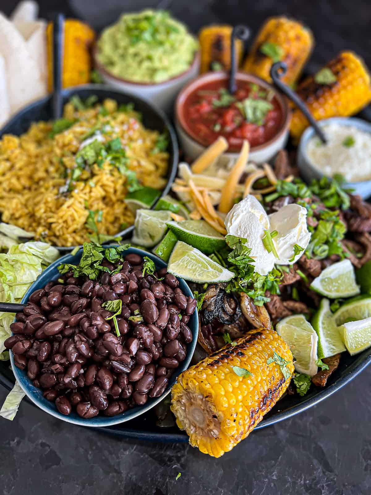 Fajitas Platter with Corn on the cob and other side dishes 