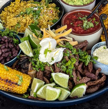 Griddled Steak Fajitas Dinner Platter with condiments and sides