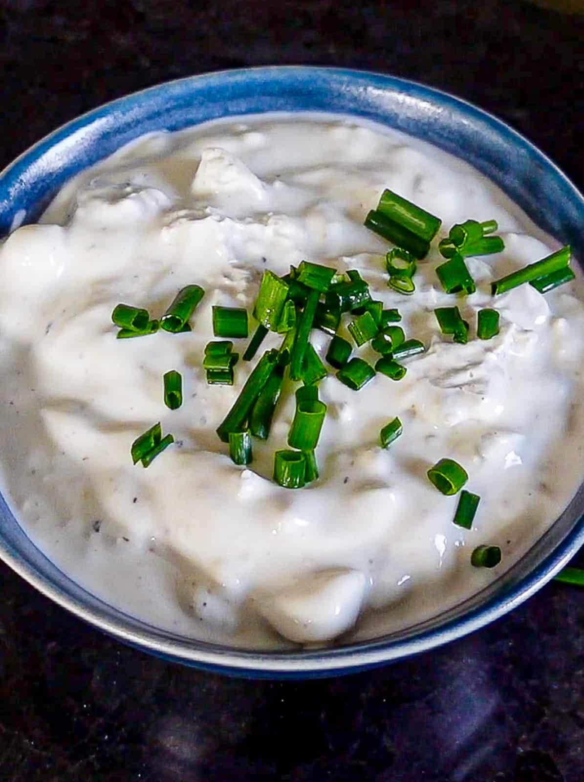 Homemade Recipe for Blue Cheese Dressing with Chives on top in a Dip Bowl