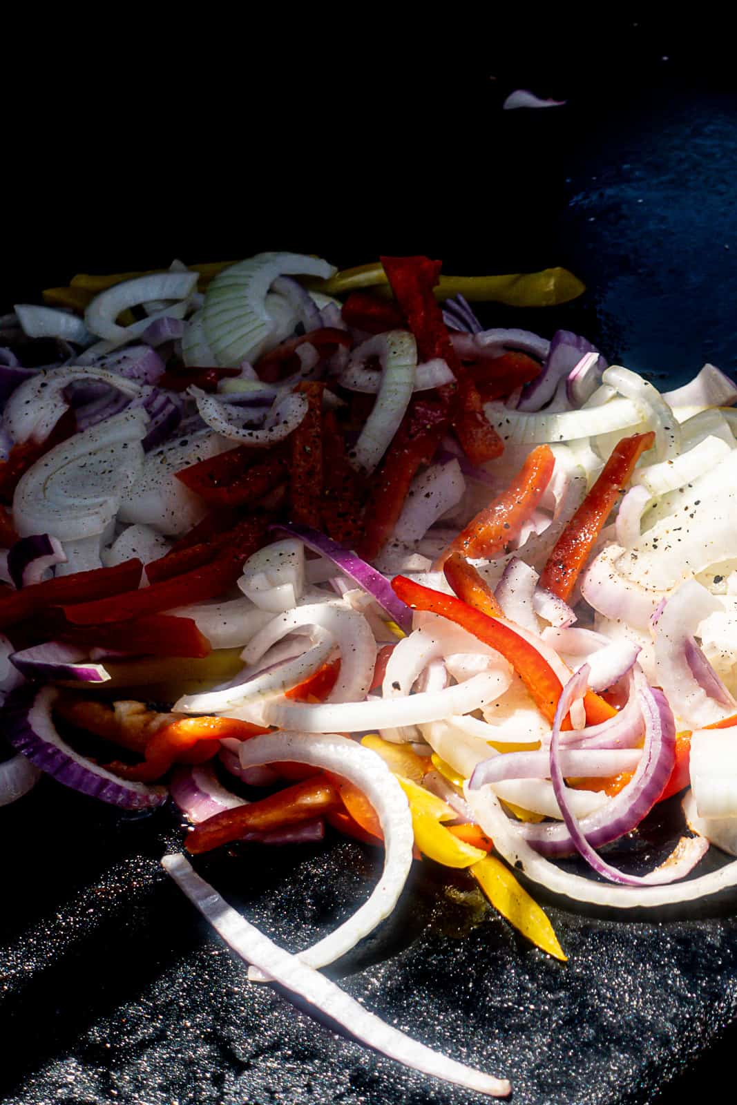 Traeger Flatrock Griddle Cooking Onions and Peppers for Breakfast Burgers 