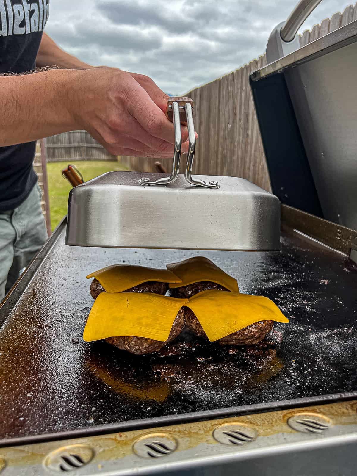 Cooking Blackstone Burgers with Cheese melted in a griddle dome Recipe