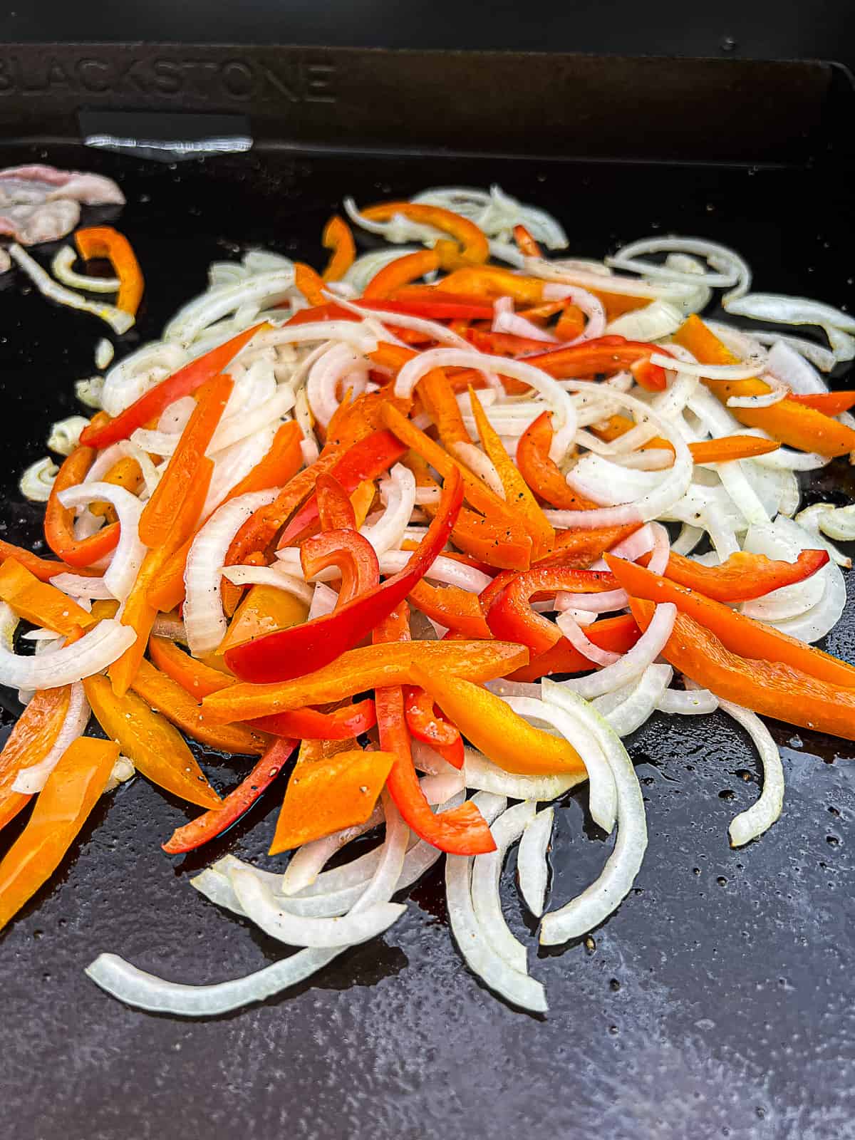 Cooking onions and peppers on Blackstone Grill