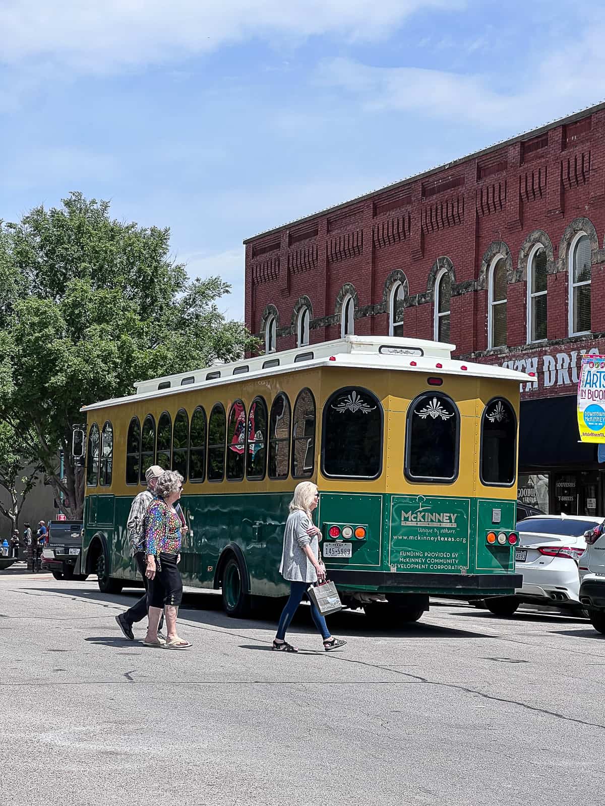 Historic Downtown McKinney Square and McKinney Trolley with tourists crossing street