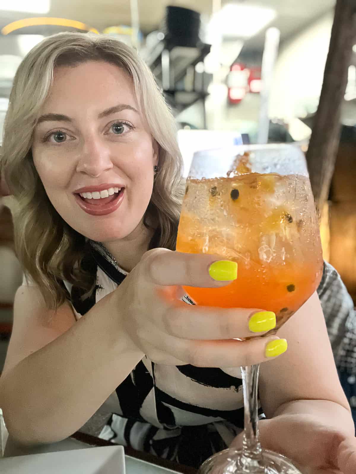 Travel Blogger Jenna Passaro with Passionfruit Cocktail at Princesa Gastrobar