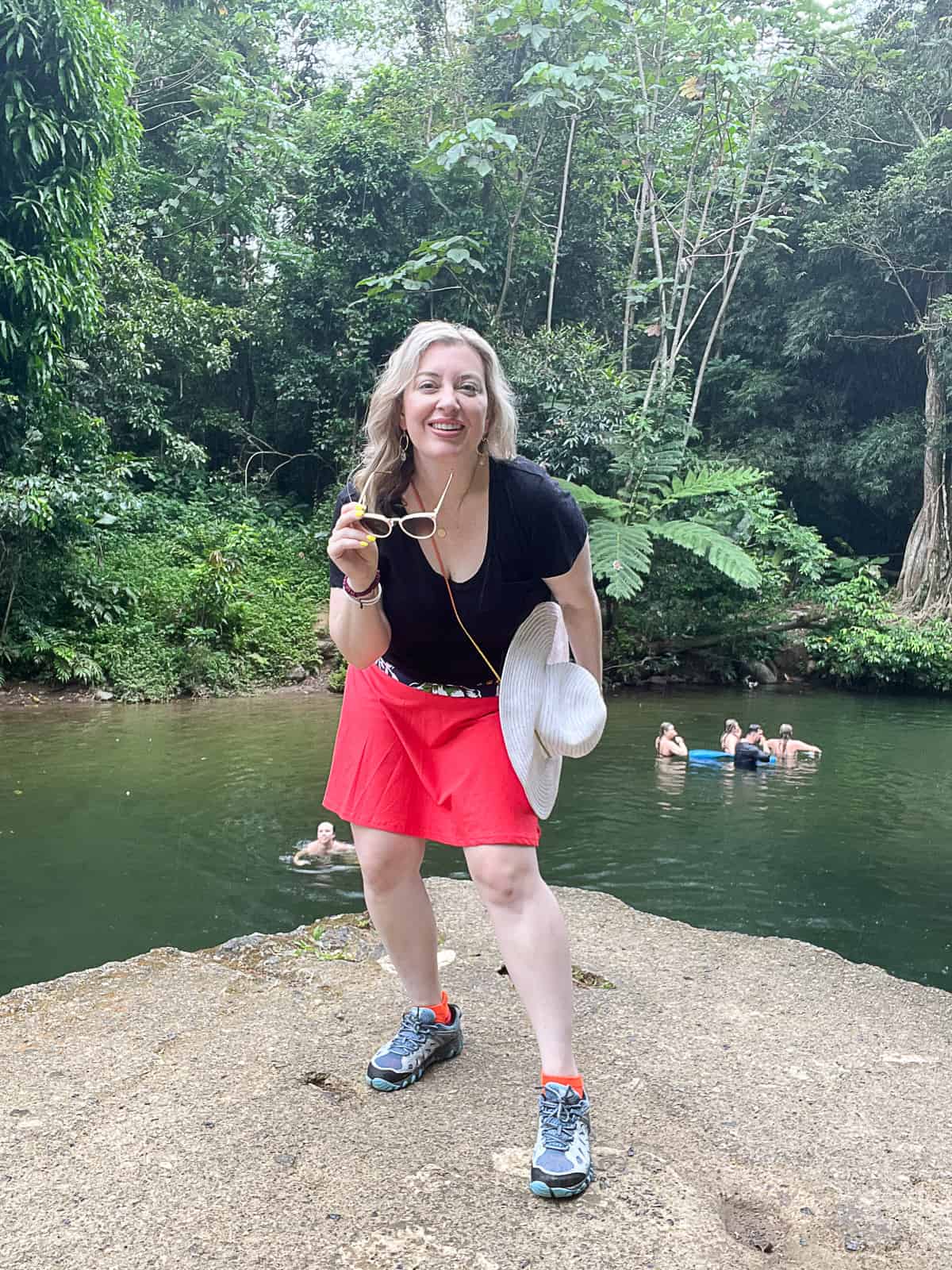 Tourist Visiting El Yunque Puerto Rico Rainforest with Family Swimming In Background