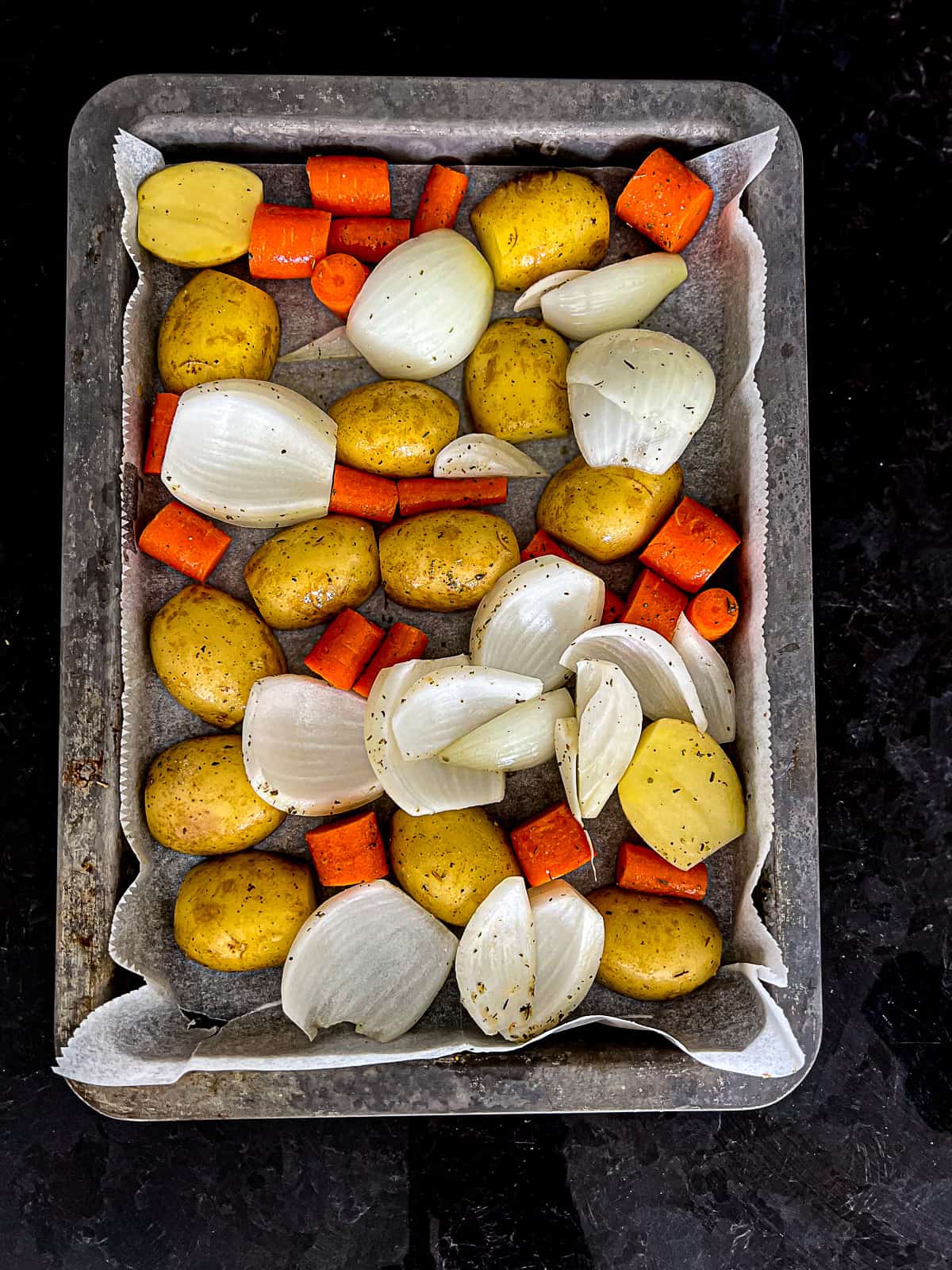 Potatoes Onions and Carrots on a Roasting Tray