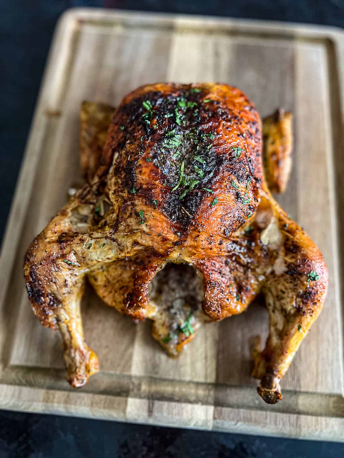 Roasted Chicken resting on a butcher block