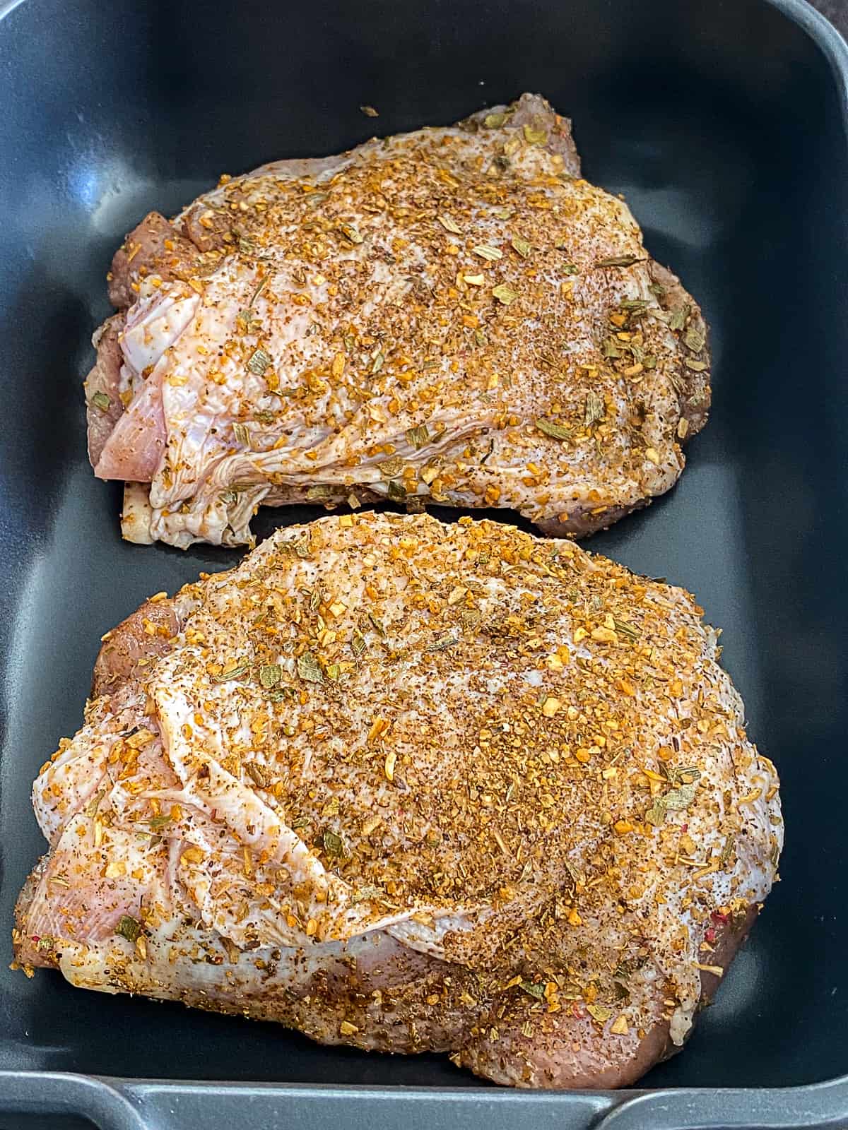 Seasoned Turkey Thighs in a roasting pan