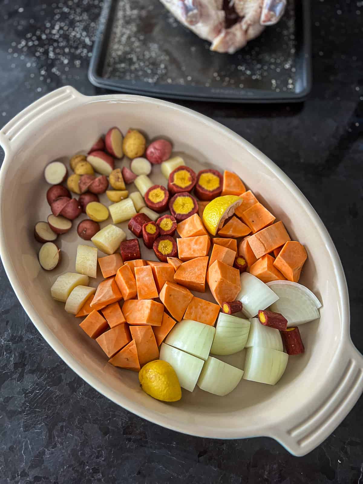 Preparing vegetables to cook under whole chicken at 375 degrees F