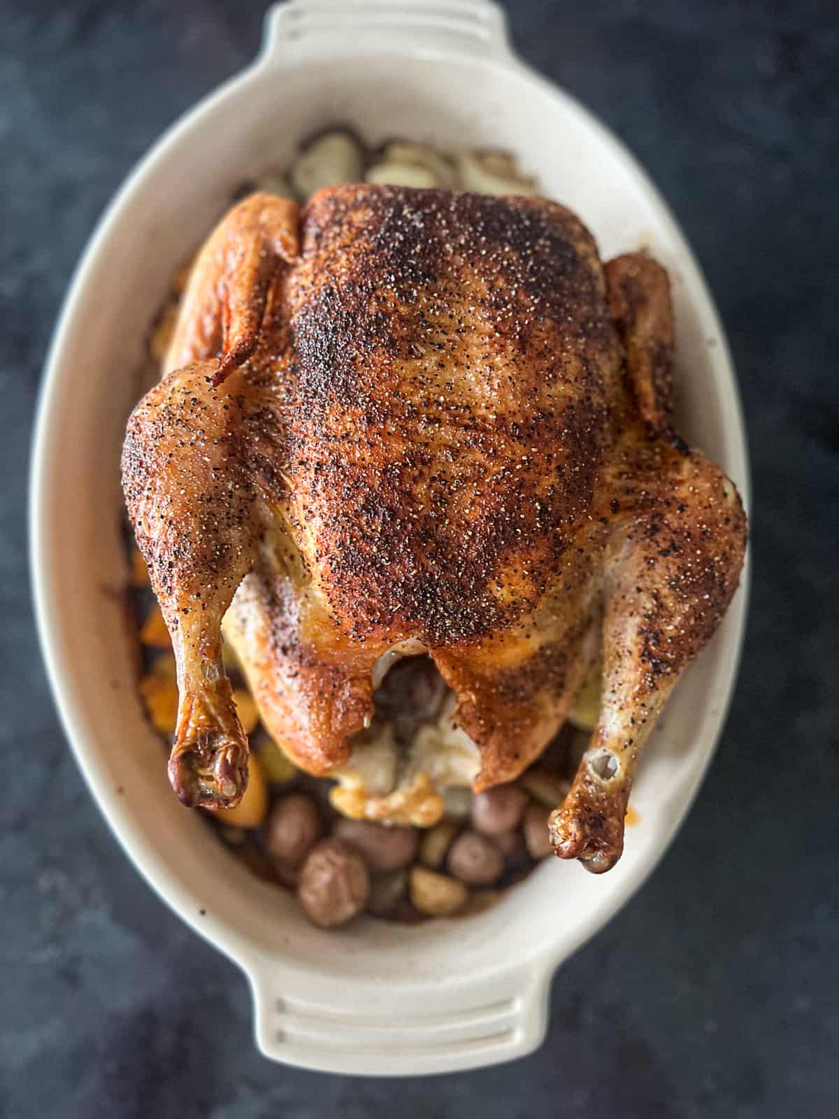 Roasted whole chicken in oven cooked at 375 degrees F
