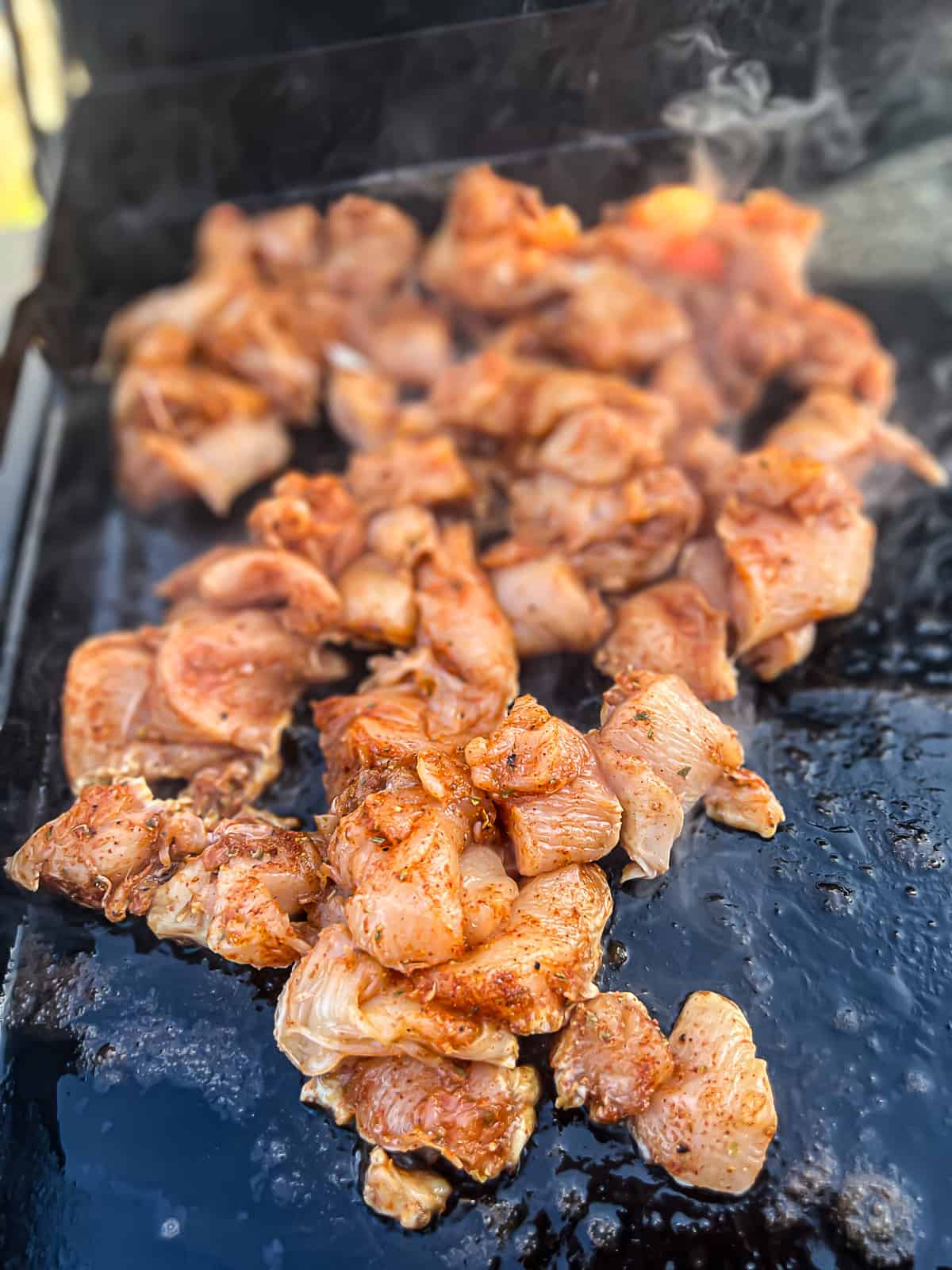 Cooking chicken with spices on a Traeger griddle