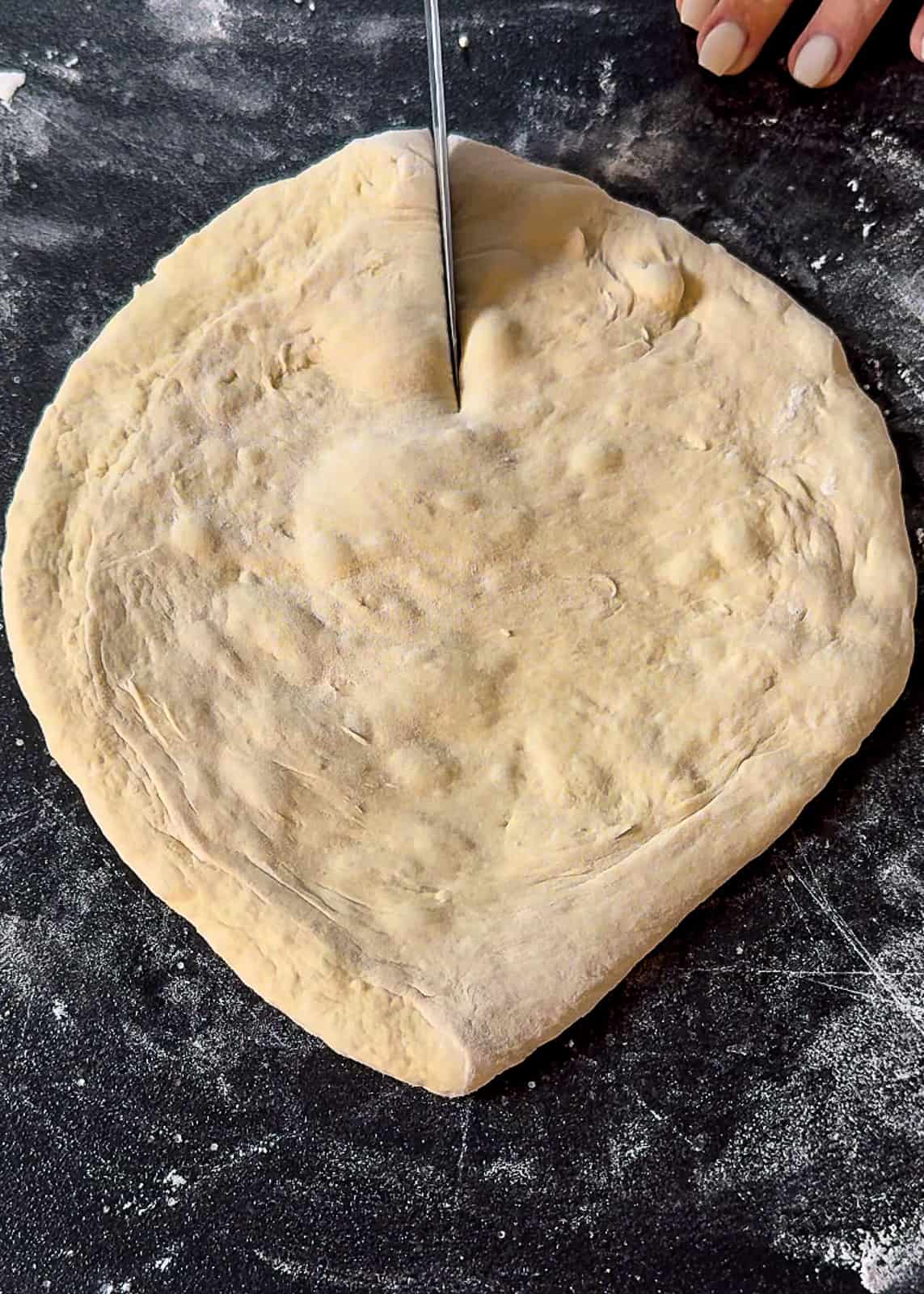Cutting a heart shape into pizza dough