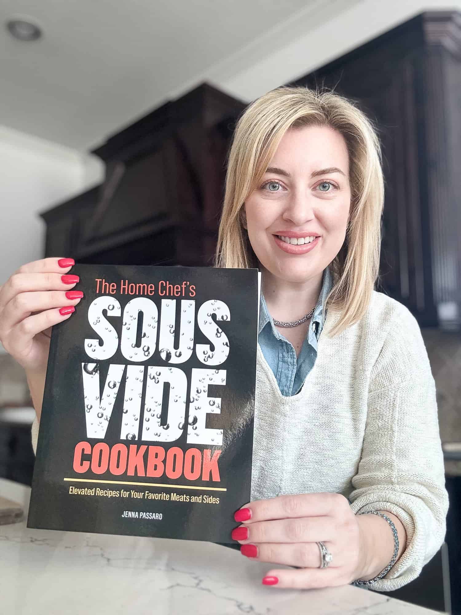 Food Blogger Jenna Passaro holding The Home Chefs Sous Vide Cookbook