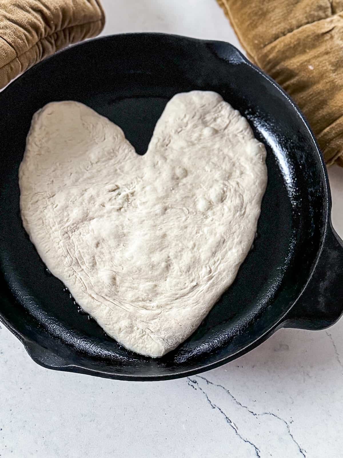 Heart Shaped Pizza Dough in cast iron skillet